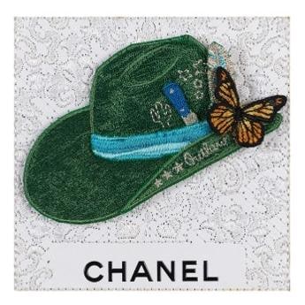 Embroidered green cowboy hat with monarch butterfly on white Chanel lace, mixed media by Stephen Wilson