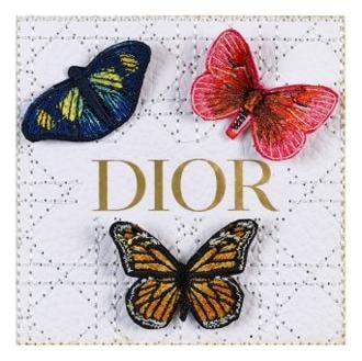 Three embroidered butterflies on white Dior cannage leather, mixed media by Stephen Wilson