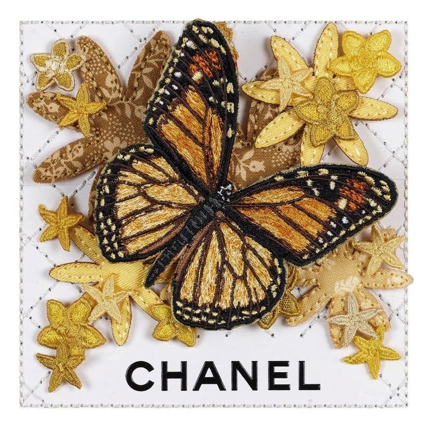 Embroidered monarch butterfly with gold flowers on white quilted Chanel leather, mixed media by Stephen Wilson