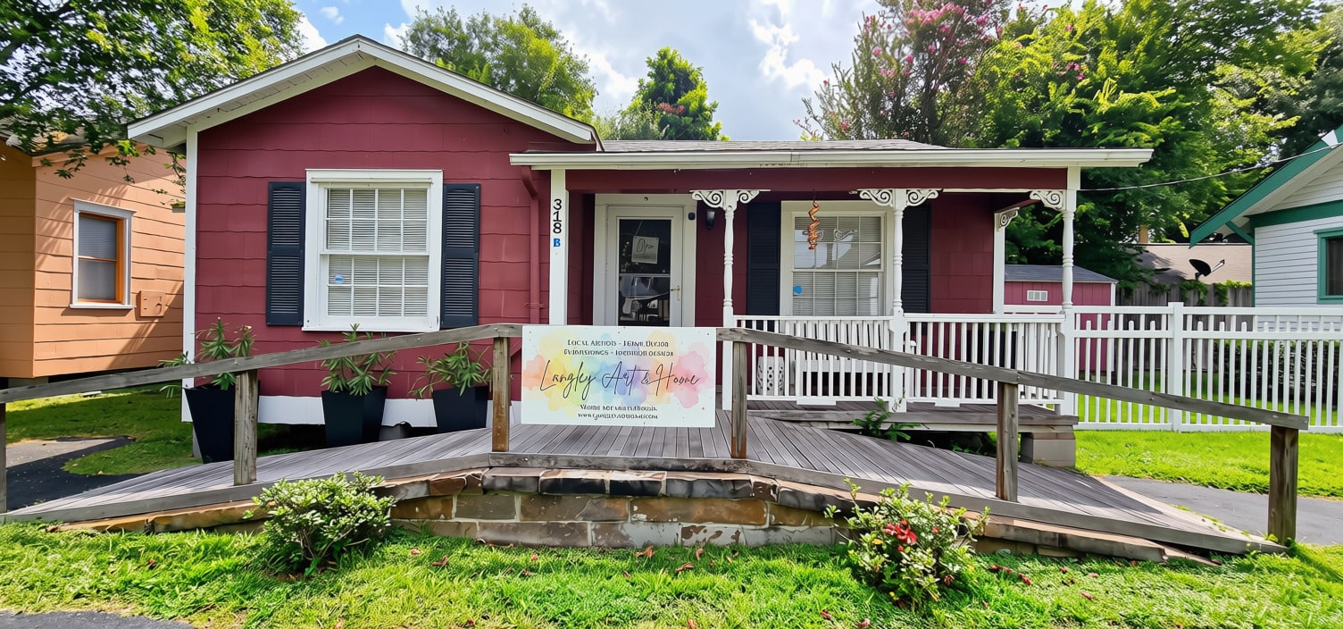 The red cottage storefront of Langley Art & Home at 318 Main Street in Old Town Spring, Texas