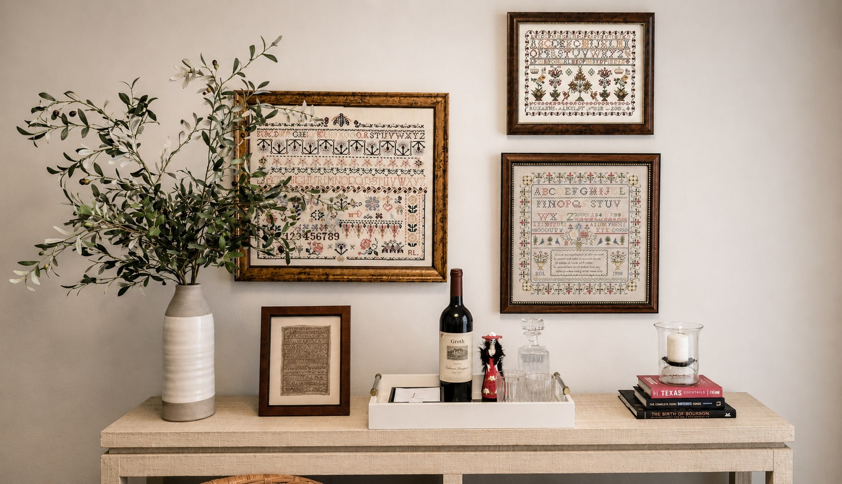 Console styling with art, lamps, and collected objects by Langley Art & Home