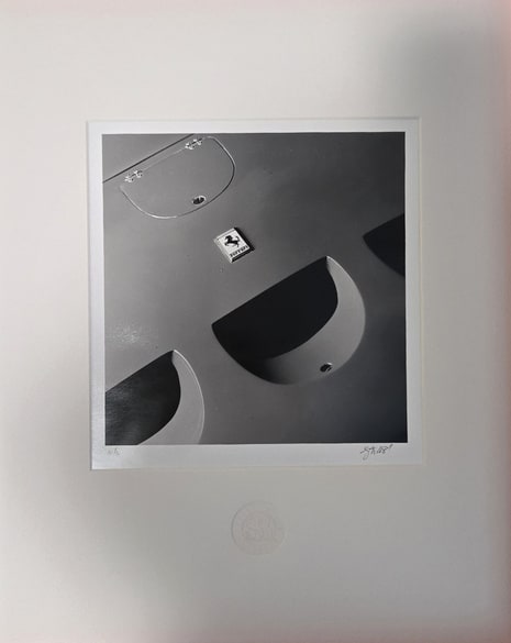 One of the nine matted black and white photographs, signed and numbered by the artist.